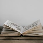An open book with illustrations on a wooden surface.