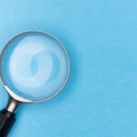 a magnifying glass on a blue background
